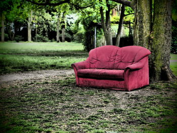 Close-up of abandoned chair on landscape