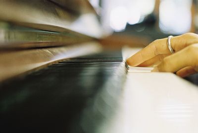 Cropped hand playing piano