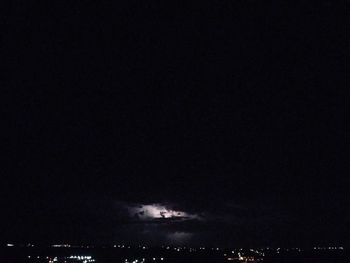 Aerial view of illuminated city against sky at night