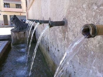 Water fountain against built structure