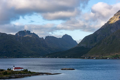 Scenic view of sea and mountains against sky