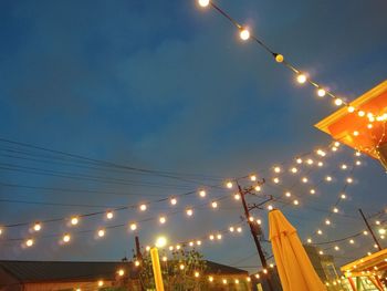 Low angle view of illuminated street light against sky at night