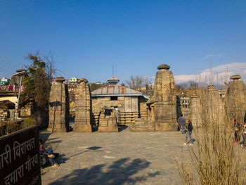 Exterior of temple against clear blue sky