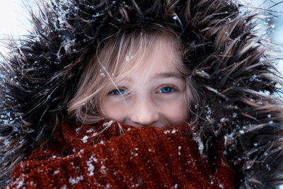Close-up portrait of girl with snow