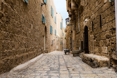 Narrow alley amidst buildings in town