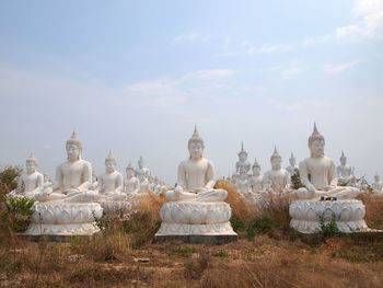 View of white temple against cloudy sky