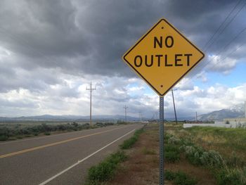 Road sign against sky