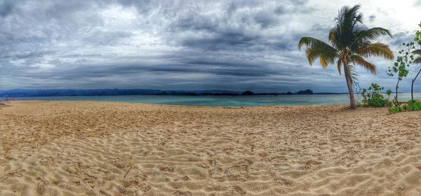 Scenic view of sea against cloudy sky