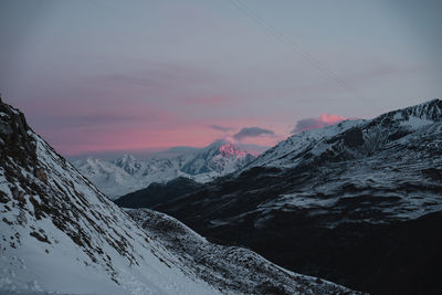 Scenic view of snowcapped mountains against sky during sunrise