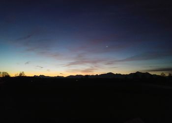 Silhouette landscape against sky during sunset