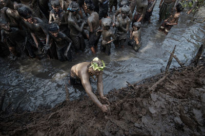 High angle view of people in muddy river