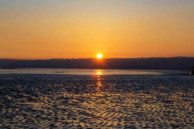 Scenic view of sea against romantic sky at sunset