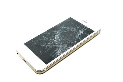 High angle view of broken glass against white background