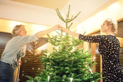 Women decorating christmas tree