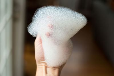 Close-up of hand holding ice cream