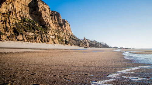 Scenic view of beach against clear sky