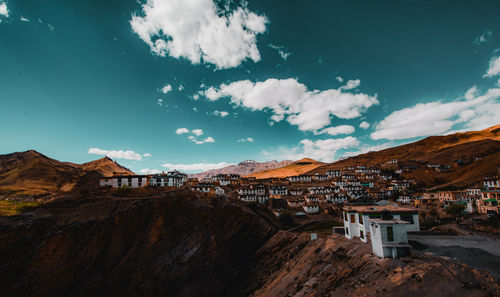 Houses on mountain against blue sky