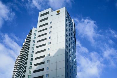 Low angle view of modern buildings against blue sky