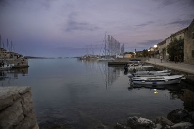 Boats in harbor at sunset