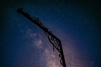 Low angle view of silhouette text against sky at night