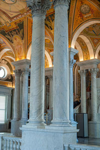 Low angle view of illuminated colonnade in building