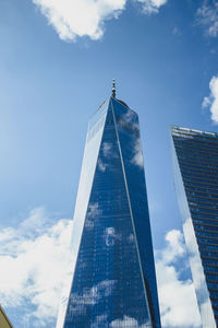 Low angle view of modern building against cloudy sky