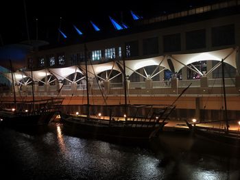 Illuminated bridge over river at night