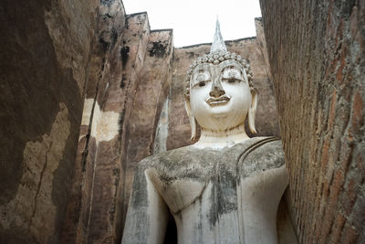 Statue of buddha against building