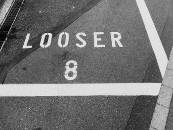 High angle view of looser text with number 8 on road