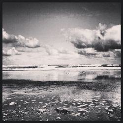 Scenic view of sea against cloudy sky