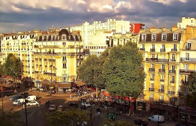 Buildings against cloudy sky