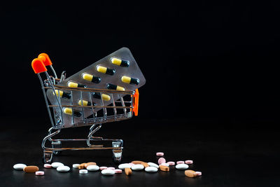 Close-up of illuminated lighting equipment against black background