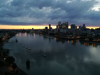 View of city lit up at sunset