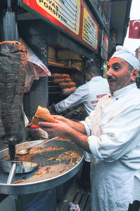 Midsection of man preparing food at market