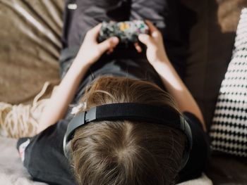 Boy playing video game at home