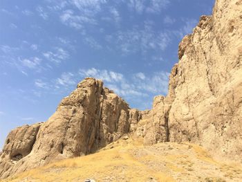 Low angle view of rock formations against sky