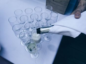 Cropped image of hand pouring champagne in flute