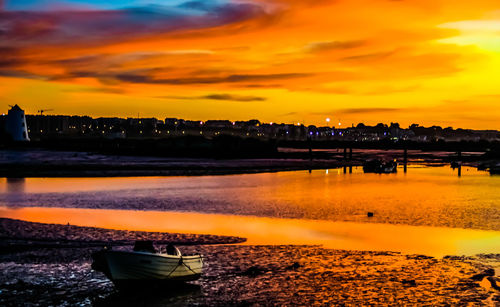 Scenic view of sea against orange sky