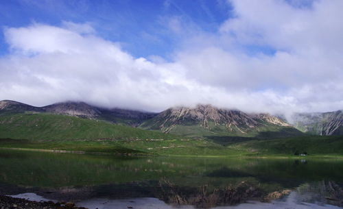 Scenic view of lake and mountains against sky