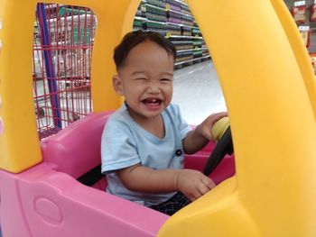 Portrait of happy boy playing in playground