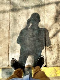 Low section of man standing on cobblestone