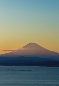 Scenic view of sea against clear sky during sunset