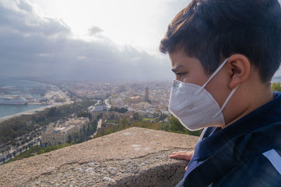 Portrait of boy looking at city