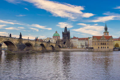 Panoramic view of ancient prague old town, karluv most in foreground, vltava river, tower and church