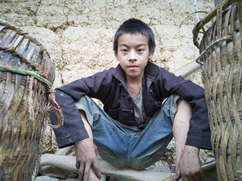 Portrait of young man sitting outdoors