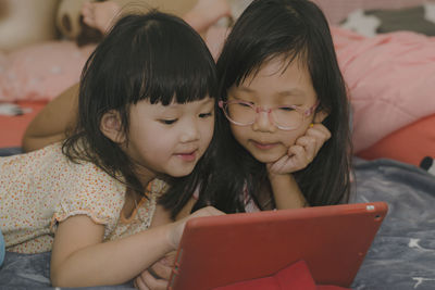 Close-up of girl looking away while using smart phone
