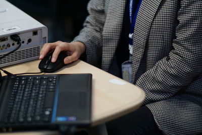 Midsection of man using laptop