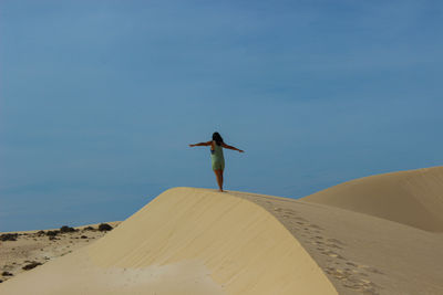 Low angle view of bird flying against sky