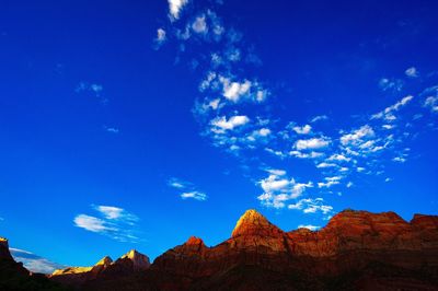 Low angle view of mountain against blue sky