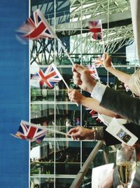 Close-up of hand holding flag in city